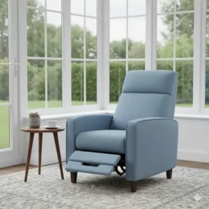 A slimline light blue fabric recliner armchair positioned in a bright conservatory, ideal for smaller UK homes.