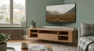 Modern oak floating TV stand for a 65 inch TV mounted on a neutral-coloured wall in a minimalist lounge setting.