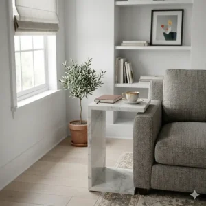 A slimline C-shaped side table providing a practical surface in a compact flat or small apartment living area.