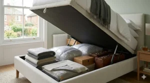 An affordable king size ottoman bed base lifted to show spacious under-bed storage for spare bedding.