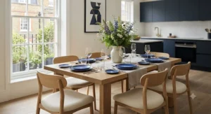 A spacious six-seater rectangular dining table and chairs arranged for a dinner party.