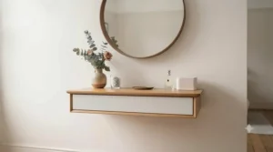 Wall-mounted dressing table shelf providing a minimalist makeup station for small rooms.