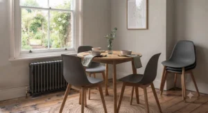 Close-up of sturdy wooden legs and durable stitching on an affordable dining chair under £100.