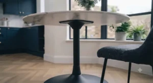 Demonstrating easy upkeep by wiping down a stain-resistant marble effect dining table surface with a soft microfibre cloth.