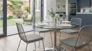 Modern wire-frame metal dining chairs fitted with grey upholstered seat cushions for extra comfort during family meals.