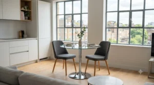 A space-saving glass top dining table making a small apartment dining area feel larger and brighter.