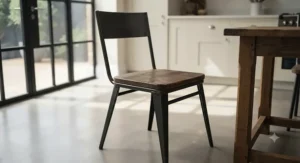Industrial-style kitchen chairs combining reclaimed wood seats and black metal frames.