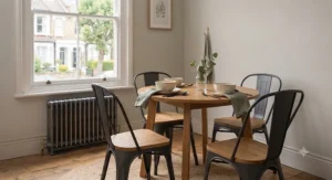 Black metal minimalist dining chairs tucked neatly under a compact kitchen table.
