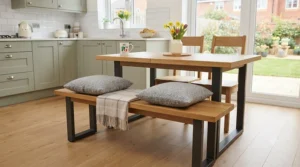 Space-saving oak-finish dining bench tucked completely under a compact dining table in a British flat.