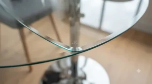 Close-up of a durable, toughened safety glass top on a modern dining table showing its heat-resistant edge.