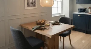 A traditional rustic solid oak dining table set inside a country cottage home with exposed brick.