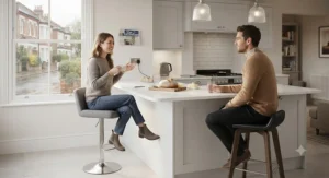 Family members sitting comfortably on a mix of adjustable bar stools and fixed-height breakfast bar stools in an open-plan kitchen.