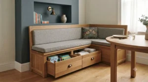 Custom-built storage dining bench fitted into a Victorian terrace alcove, paired with cosy scatter cushions.