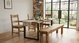 A rustic oak dining bench and chair set combination featuring natural wood grain textures in a country cottage.
